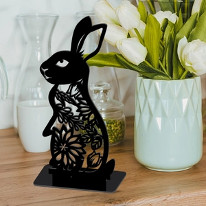 Detail of black Easter bunny silhouette featuring intricate hollow flower patterns