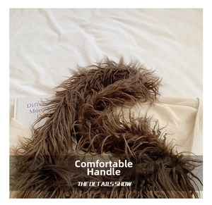 Detailed view of dark brown plush handle and off-white twill woven bag material