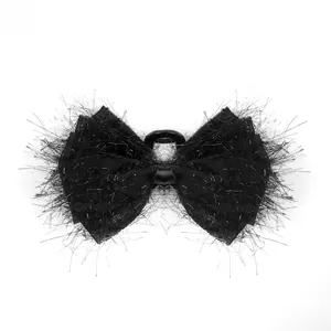 Detail view of large black chiffon bow hair claw clip with fuzzy texture and durable teeth