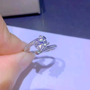 Classic four-prong solitaire ring with one carat round stone and diamond-encrusted band