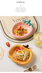 Detail of strawberry and pumpkin shaped ceramic dessert plates with food on table
