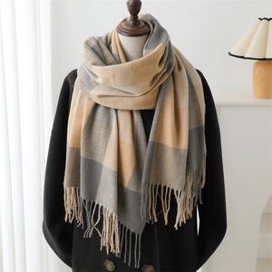 Close-up of beige and grey plaid scarf with soft fringe detail on a mannequin