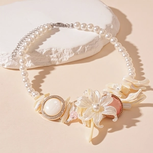Elegant shell-style floral necklace with white pearls and gold resin accents