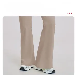 Detailed view of light brown flared yoga pants showing long slim fit and smooth fabric texture