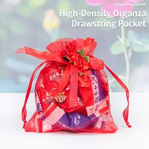 Red organza drawstring gift bag featuring decorative roses and a mesh texture for candies