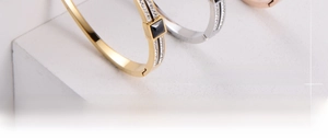 Detailed close-up of square black gemstone bracelets with diamond accents on marble