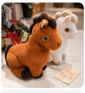 Detail of plush pony toys with sun-shaped eye embroidery on soft fluffy carpet