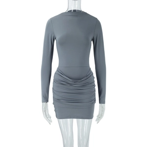 Detailed view of the side ruched texture and elastic fabric on a grey mini dress