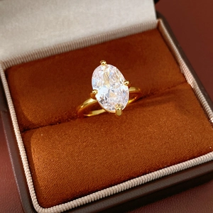 Close-up of 18k gold plated ring with oval cubic zirconia in four-prong setting