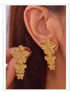 Close-up of model wearing 18K gold plated stainless steel triple flower pearl earrings