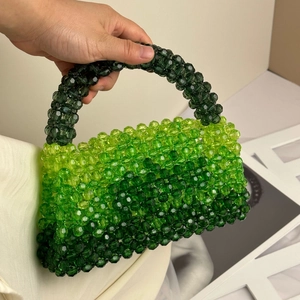 Detail of green gradient beaded handbag with three-tone handmade woven crystal beads
