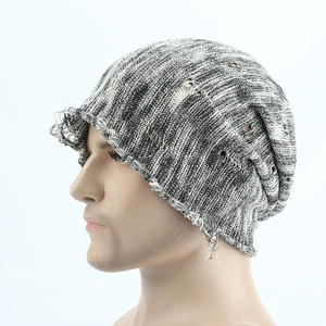 Distressed black and white knit beanie with ripped details and retro slouchy street style