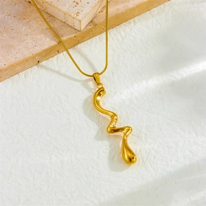Irregular curved wave pendant necklace in gold plated stainless steel on marble base