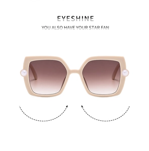 Detail view of square beige kids sunglasses with gradient lenses and pearl decor