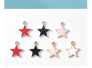 Macro shot of colorful star pendants with enamel finish and gold or silver metal frames