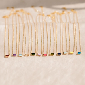 Elegant gold necklace set with twelve colors of rectangular cut birthstone pendants