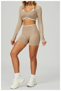 Detail of high-stretch yoga set featuring contrast trim sports bra and high-waist shorts