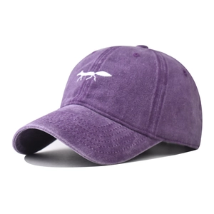 Macro detail of white fox embroidery on vintage washed purple cotton baseball cap