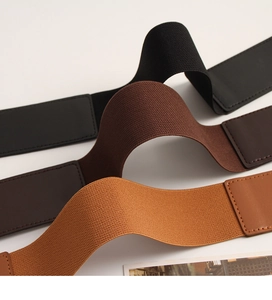 Detailed view of elastic waist belts in black, brown, and khaki with leather accents
