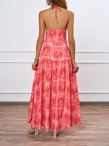 Detailed back view of a pink halter neck dress with red palm tree patterns for summer