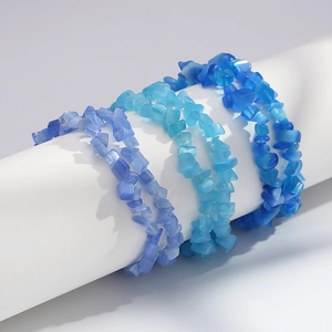 Close-up of three blue cat eye stone chip bracelets on a white display stand