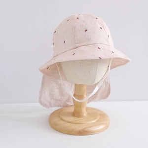 Détail d'un chapeau rose avec broderie fraise et protection de nuque pour petite fille
