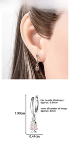 Detailed view of silver fishbone wing earring with dimensions and pink bead accent