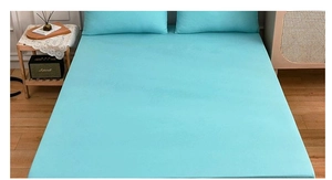Turquoise blue fitted sheet and pillowcase set on wooden bed in modern bedroom