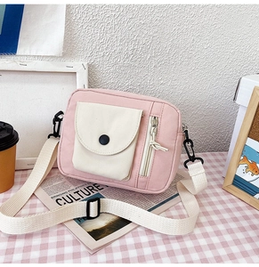 Pink canvas bucket bag with cherry design, multi-pockets, and adjustable shoulder strap