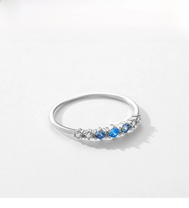Macro shot of S925 sterling silver ring with gradient blue and white zircon stones