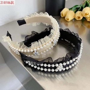 Close-up of pleated mesh headband with double row pearls and floral decoration
