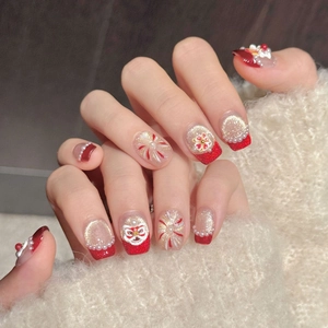 Festive Chinese New Year press-on nails with red lion dance motifs and gold glitter accents