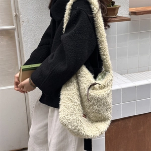 Detail of cream sherpa tote bag showing green checkered lining and large capacity