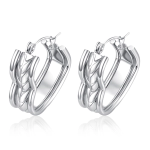 Detailed view of silver hoop earrings featuring an intricate woven metal texture
