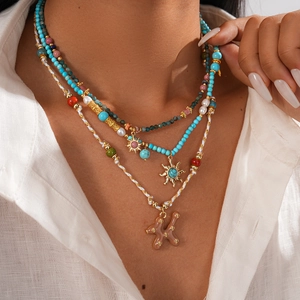 Détail d'un collier bohème multicouche avec perles turquoise et pendentif étoile solaire