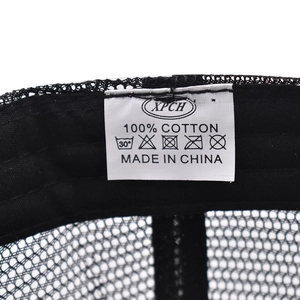 Macro view of the internal cotton wash label and breathable mesh fabric of the outdoor cap