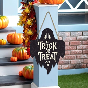 Wooden Halloween ghost welcome sign with Trick or Treat text hanging on a porch pillar