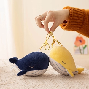 Plush whale keychains in blue and yellow colors with soft texture and golden metal hooks