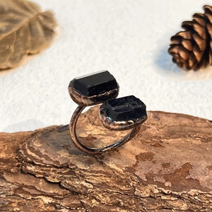 Vintage copper open ring with raw black tourmaline stones in a natural forest setting