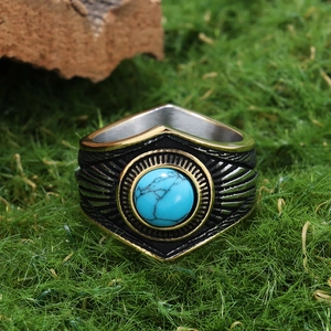 Vintage stainless steel ring with turquoise star pattern on natural moss background