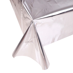 Close-up detail of shiny silver foil tablecloth texture and reflective metallic folds