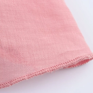 Close-up view of pink midi dress fabric texture and professional overlock stitching detail