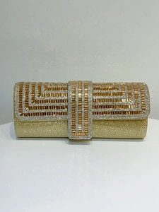 Detailed view of the gold evening clutch with sparkling rhinestones and beaded geometric patterns