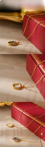 Detail of vintage 18K gold plated necklaces with iridescent opal and mother of pearl pendants
