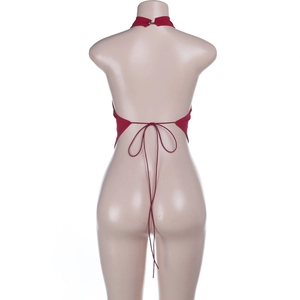 Detail of red halter top featuring open back design and adjustable lace-up straps