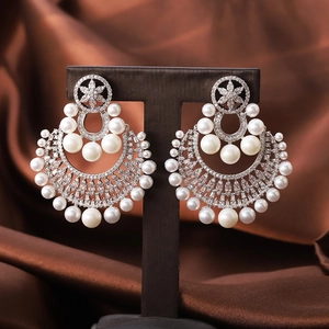 Baroque floral pearl drop earrings with sparkling crystals on a luxury satin background