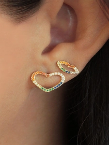 Close-up of heart and lip earrings with rainbow zircons on model ear