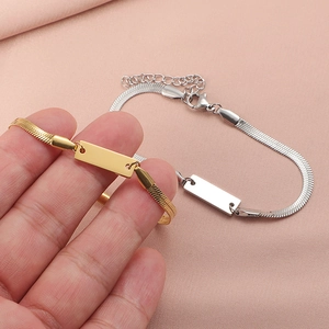 Minimalist gold and silver flat snake chain ID bracelets for women on pink fabric