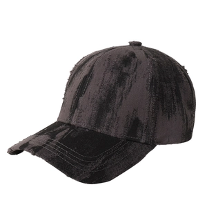 Distressed dark grey tie-dye baseball cap with vintage frayed edges and cotton texture