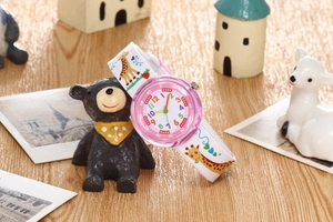 Detail of children's giraffe watch with white silicone strap and pink translucent case